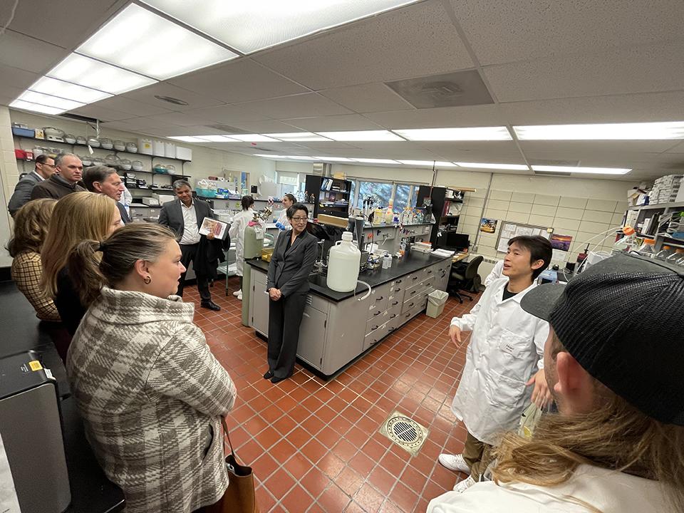 Group of people listen to research in PPIC lab.